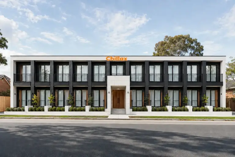 Modern black-and-white two-storey Melbourne student accommodation with twenty studios, timber doors, a white-stone entrance and an illuminated orange Chillax sign